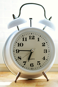 white alarm clock with bells